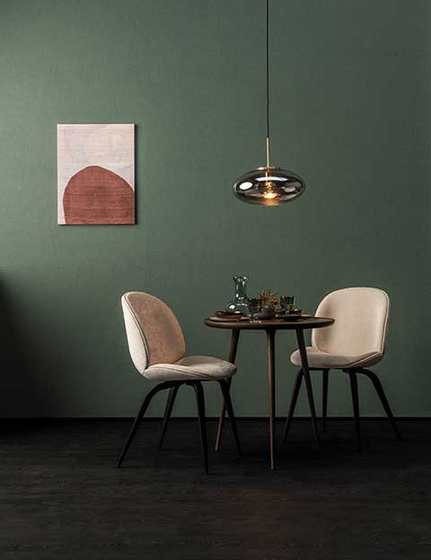 high performance texture green wall behind a table and chairs