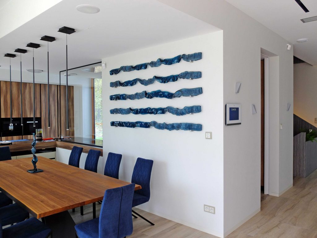 adriatic waves glass art pieces on wall in a dining room