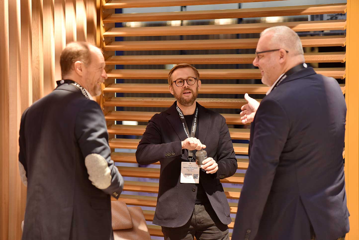 three attendees networking at cruise ship interiors expo europe 2021