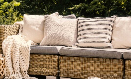 Girones outdoor fabrics featured on a wicker sofa and footstool