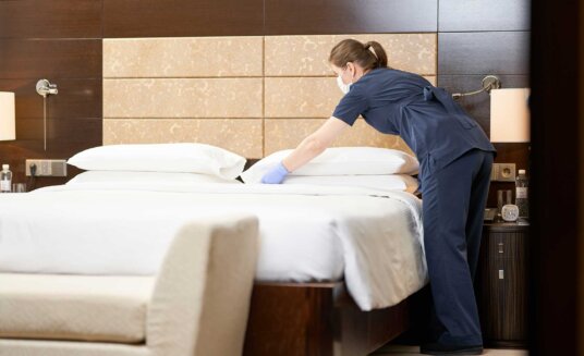 cleaning staff changing the bedsheets