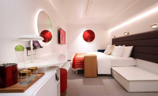 virgin voyages insider cabin at night with the bed folded down
